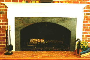 Private Residence, Chapel Hill. This fireplace, with a soft radius on the header was fabricated out of Verde Candais granite. This stone is a deep, rich green with burgundy accents woven into the softly swirling pattern. This particular firebox was designed to be extra wide and nicely a