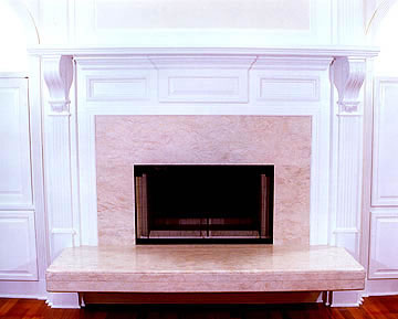 Private Residence, Durham. This fireplace was designed to be used from two rooms: the living room and master bedroom. This side, featuring the living room, has a cantilevered, raised hearth underneath which wood can be stored. Prescott Stone Fabricators designed and installed the s