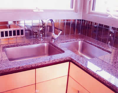 Private Residence, Hillsborough. Violetta granite, quarried in Saudi Arabia, was utilized for the counters in this kitchen. Due to the hardness and strength of this particular granite, we were able to cut two large holes, side by side, and configure two undermount sinks as preferred by t